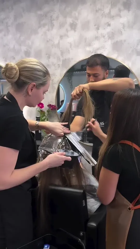 Colourist toning blonde highlights at the backwash basin, Capel Street Dublin