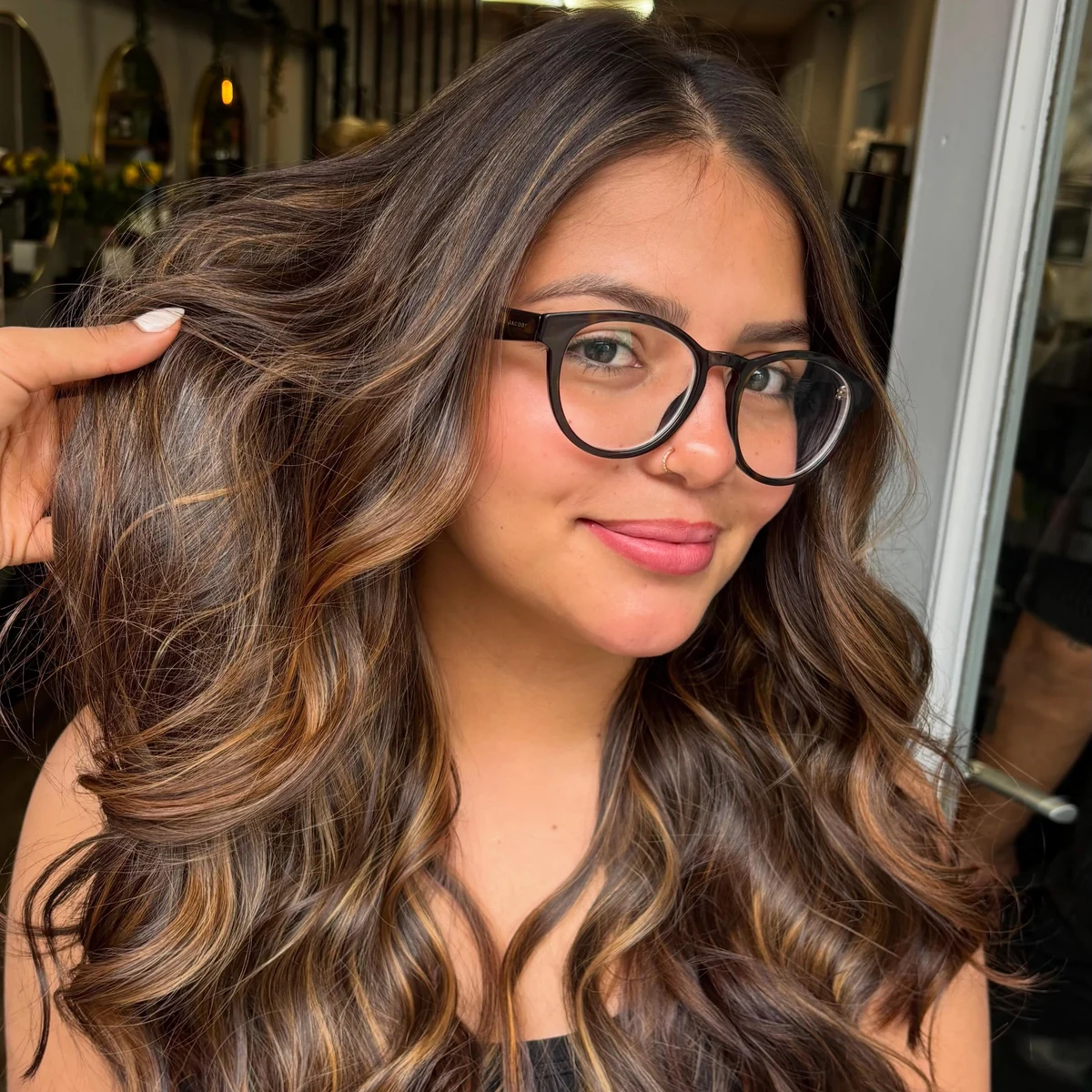 Smiling client showing her caramel-highlighted wavy hair styled at Blend Beauty Artisans, Capel Street Dublin