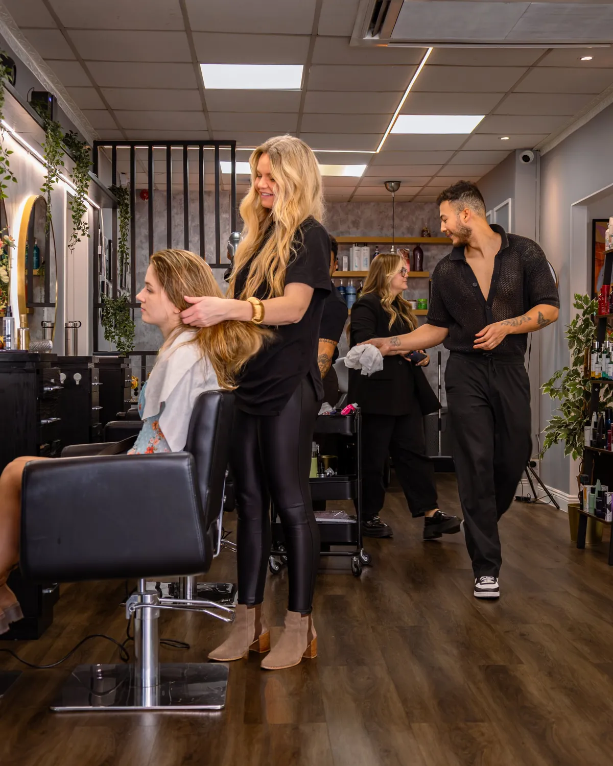 Stylists working with clients inside Blend Beauty Artisans.